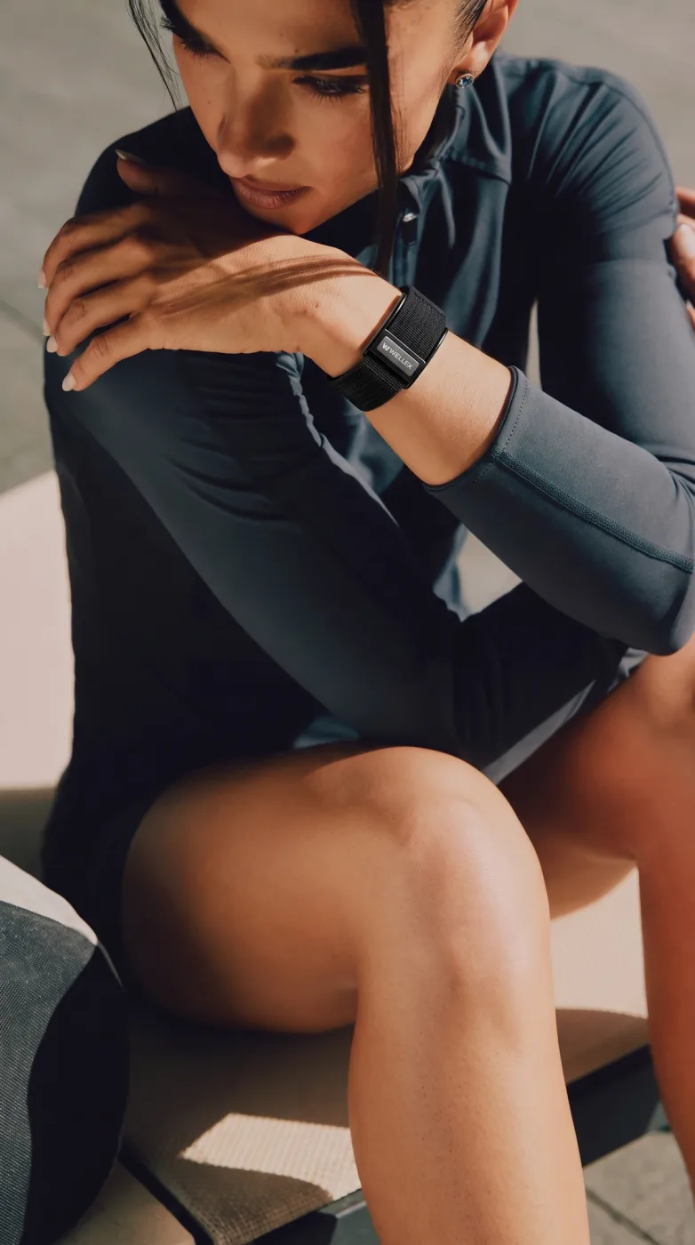 An athlete resting, wearing a Wellex band
