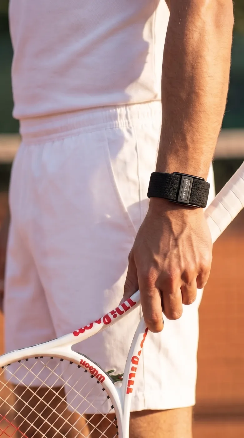 A wrist wearing the band against a plain white shirt