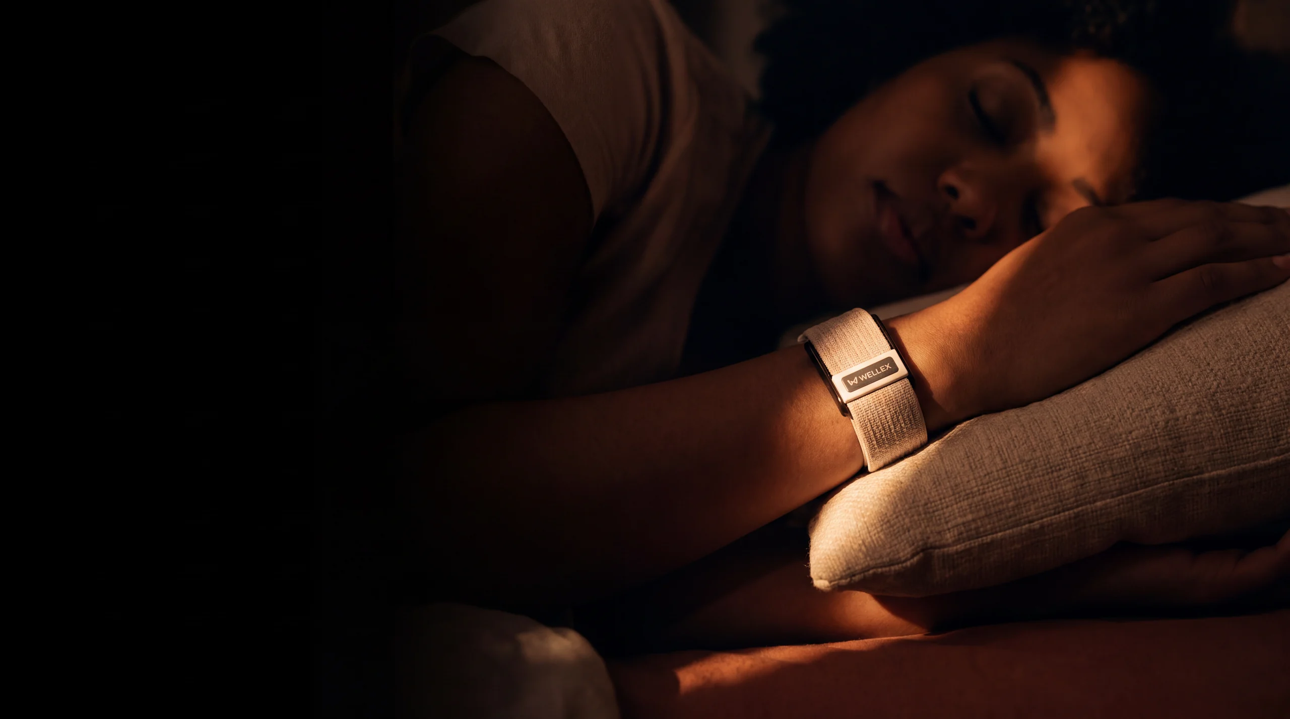 A dim room at night, the band still on the wrist